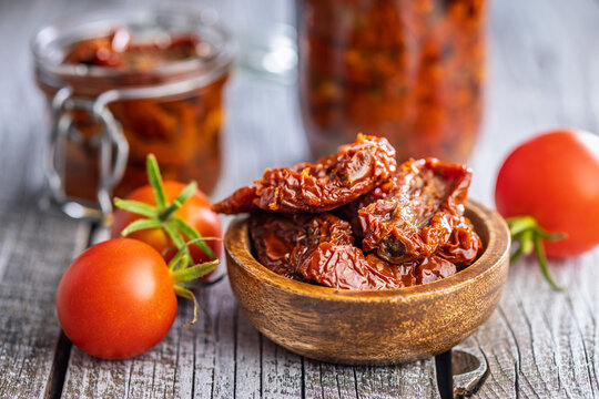 Sun-Dried Tomatoes in Olive Oil in a Rustic Bowl With Fresh Tomatoes and Preserved Jars