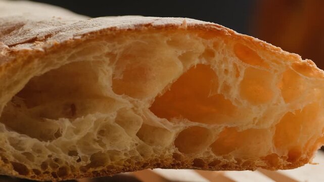 Baguette Bread torn apart by hand, fresh baguette crumb close-up macro shot showing soft airy texture