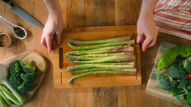 Fresh green asparagus on kitchen with broccoli and green pepper, vegan healthy food. Bunch of green asparagus close-up