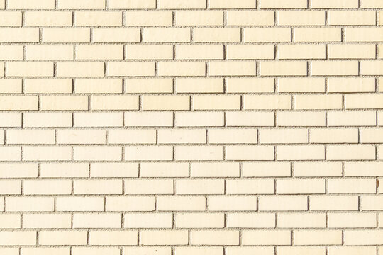 Light beige brick wall background showing texture and pattern