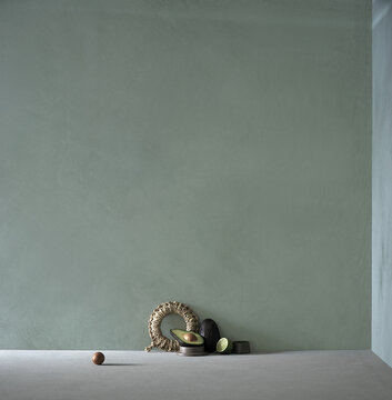Minimalist still life with avocado on sage green limewash wall background