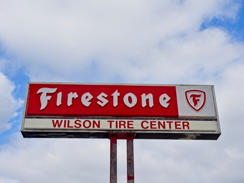 Firestone automotive service center sign against cumulus cloud filled sky &mdash; Texarkana Texas, November 16, 2025