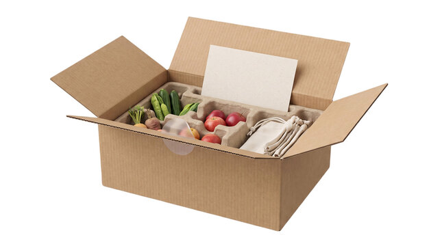 Open cardboard delivery box with fresh produce and blank paper card