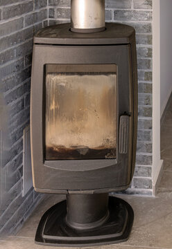 Closed old dirty burning stove inside residential home interior