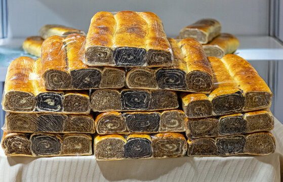 Poppy seeds roll sweet pie sold outside on local market stall