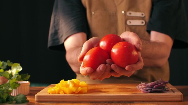 Chop tomato close up, Diced kumato tomatoes on a cutting board for Italian sauce, chef cut tomatoes with knife for gazpacho or salad 