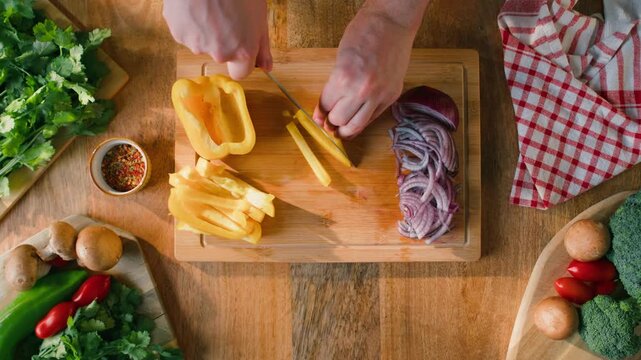Man cut yellow sweet pepper, Healthy food, Chef hands with knife for onion, cutting and preparation with cooking for dish. Restaurant, culinary service and cook with skills for catering
