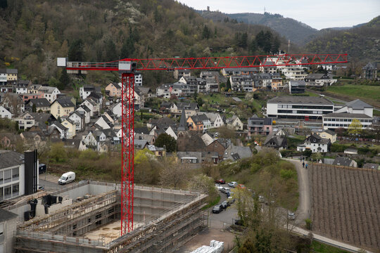 A red construction crane over a construction site 