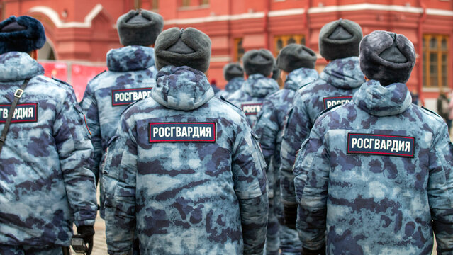 Employees of the Russian Guard in winter clothes, close-up with their backs. Rosguard detachment, Moscow, August 10 2026.