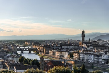 Naklejka premium Panoramic skyline view of Florence Italy with Ponte Vecchio and Palazzo Vecchio at sunset 