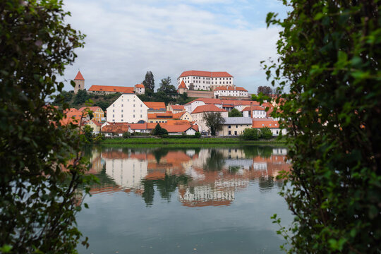 City Ptuj, Slovenia with red-roofed buildings and the Drava River. Ptuj Castle overlooks the historic city center.