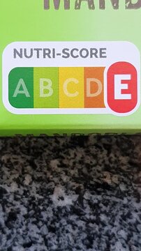 Vertical closeup of food package with E nutri-score label.