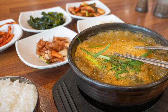 Hot spicy loach soup chueotang served with side dishes banchan at traditional local restaurant in South Korea.