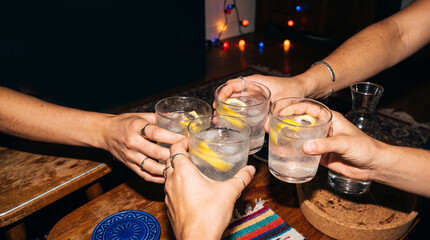 Obraz premium Friends toast with citrus drinks at home