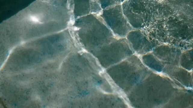 Abstract view of sunlight rippling across shallow water surfaces, creating beautiful caustic patterns, perfect for spa advertising or serene nature backgrounds, evoking calm and tranquility
