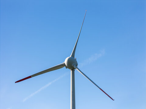 Wind turbines stand tall in a rural area, creating clean energy and promoting the shift to renewable resources.