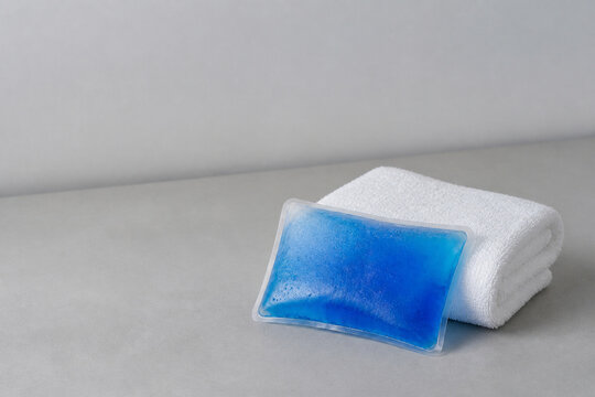 Reusable Blue Gel Cold Pack Beside Folded White Towel