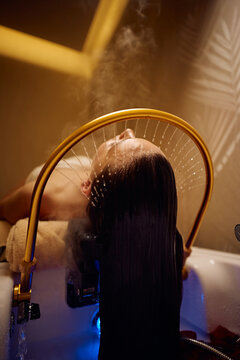 Close up of woman having her hair rinsed at Japanese head spa.