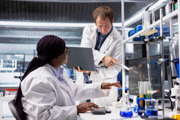 Multiethnic team of experts conducts a research study in a biolab, analyzing biological samples and...