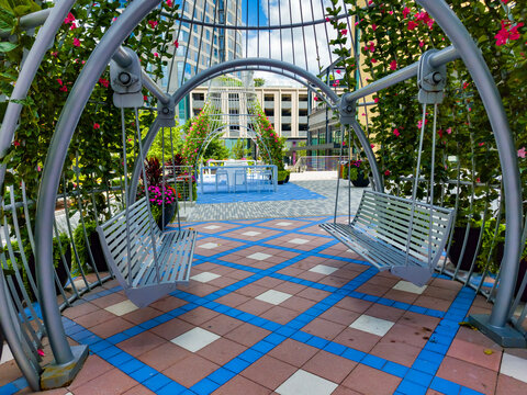 Curved metal structure and flowers form a playful outdoor gathering place in Virginia.