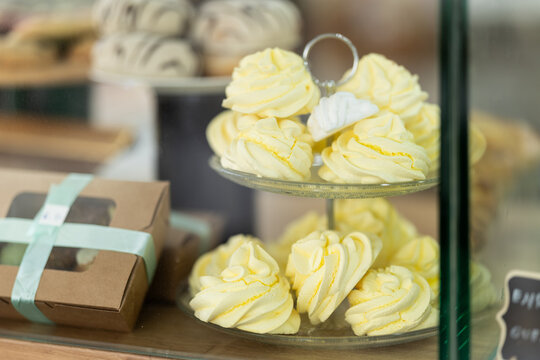 Closeup of sweet meringue swirls in the shop window