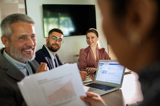 Business team reviewing report in office meeting room