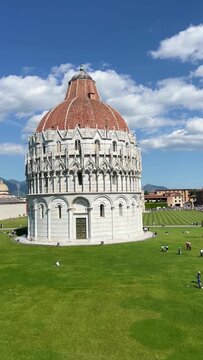 Piazza dei Miracoli in Pisa with the Baptistery of St. John, Cathedral and Leaning Tower under a blue sky, panoramic high angle view, Tuscany, Italy