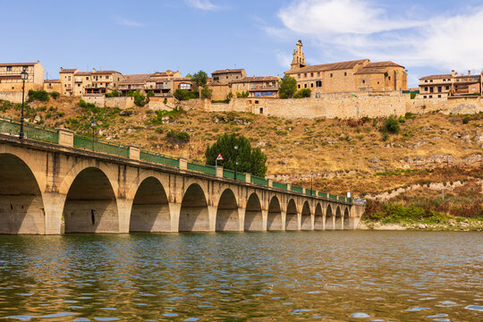 View of Maderuelo town village from opposite bank of river or reservoir. Ancient European city, former fortress city, defensive structure of Middle Ages