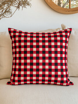 red and black gingham pattern pillow on a white sofa, Christmas decor on a sofa
