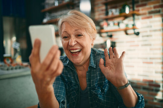 Senior woman video calling from home kitchen