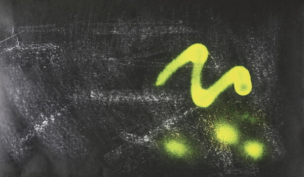 Paint stained and scratched black paper background, colorful scrabble, design element