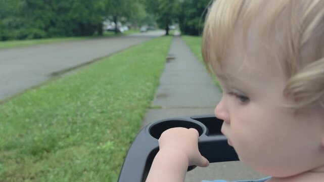 Young boy enjoying a walk in neighborhood on sidewalk 4k

