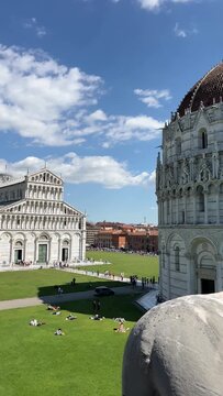 Piazza dei Miracoli in Pisa with the Baptistery of St. John, Cathedral and Leaning Tower under a blue sky, panoramic high angle view, Tuscany, Italy