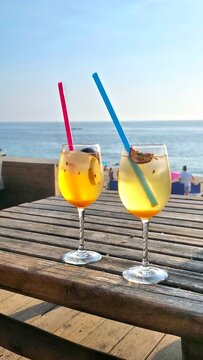 two tropical cocktail glasses on the beach