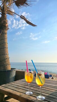 two tropical cocktail glasses on the beach