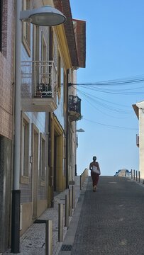 silhouette of a woman strolling in P&oacute;voa de Varzim, Portugal