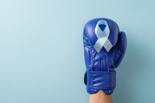 Blue ribbon on boxing glove representing men's health awareness for prostate cancer month