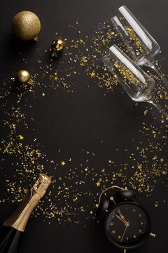Happy New Year 2027 celebration scene with champagne, clock, gold confetti and holiday ornaments on vertical dark background