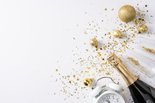 Happy New Year 2027 celebration with champagne, clock and golden decorations for winter holiday