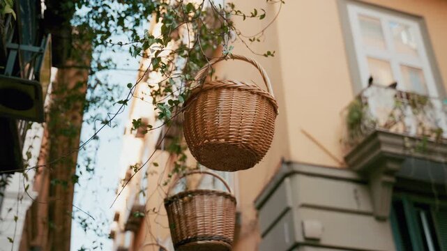 Typical Neapolitan baskets hanging between the buildings