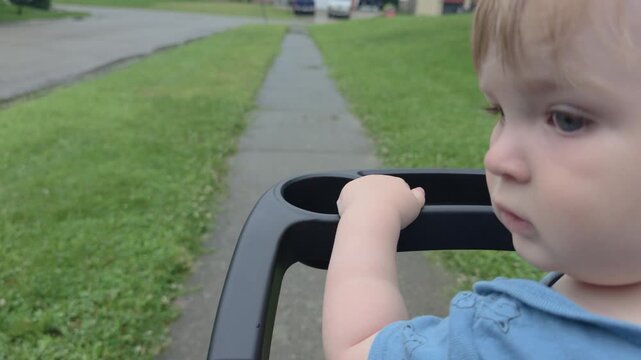 Young baby boy riding in stroller on sidewalk 4k