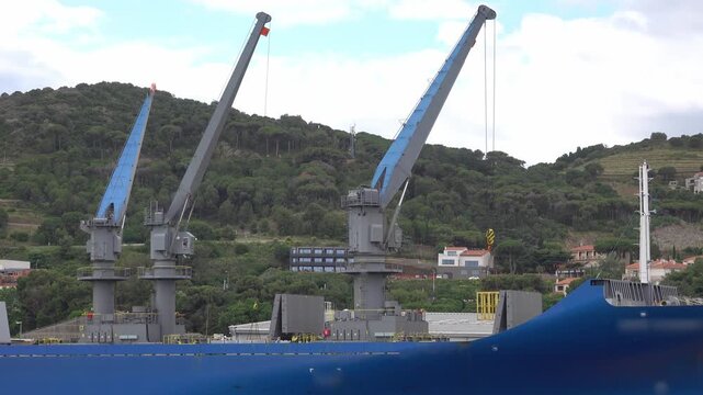 cranes to load goods in cargo ship at the dock