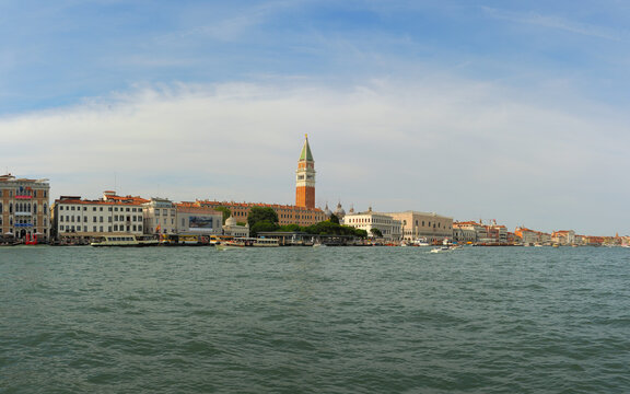 Scenic view of Venice waterfront with historic buildings, Campanile bell tower and Doge's palace across the lagoon