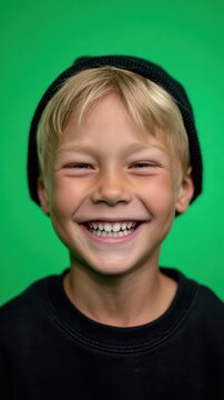 Portrait of a skater boy, bright white smile, solid green screen background