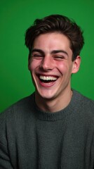 Obraz premium Young male model, huge smile, white teeth, sharp facial features, solid green screen background