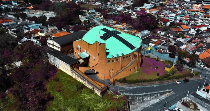 4K aerial drone view of a historic Catholic church surrounded by traditional houses and urban architecture in Santa Isabel, S&atilde;o Paulo, Brazil.