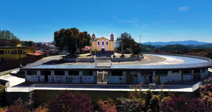 4K aerial drone view of a historic Catholic church surrounded by traditional houses and urban architecture in Santa Isabel, S&atilde;o Paulo, Brazil.