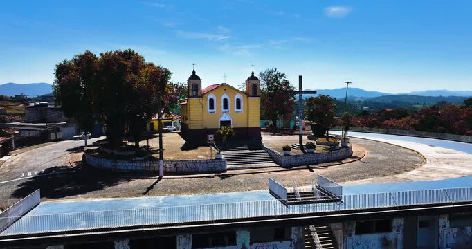 4K aerial drone view of a historic Catholic church surrounded by traditional houses and urban architecture in Santa Isabel, S&atilde;o Paulo, Brazil.