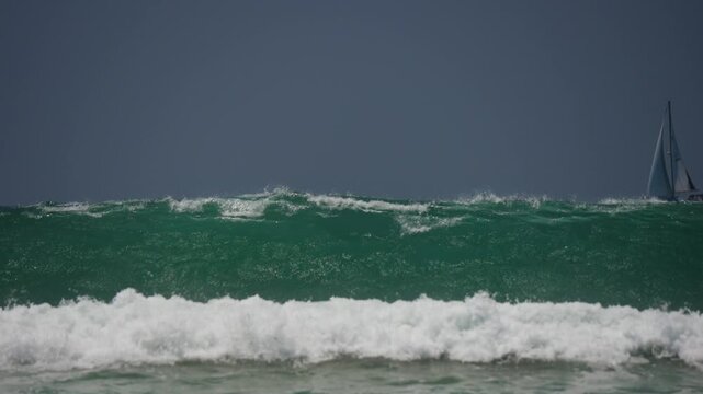 Large waves breaking on the beach in Huntington Beach CA