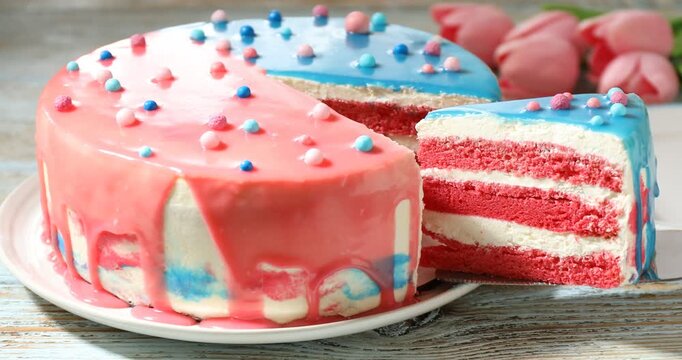 Baby gender reveal party. Taking slice of cake with pink layers at wooden table, closeup